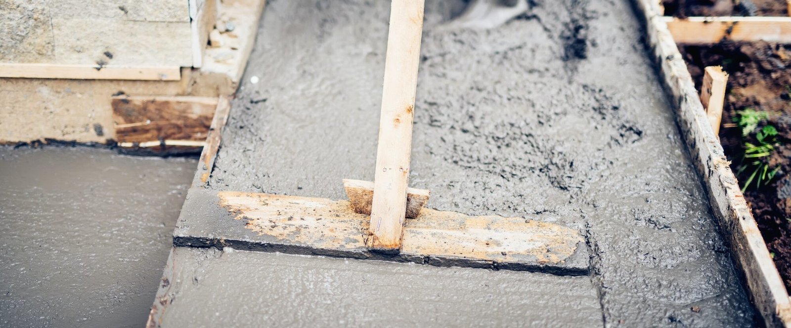 Mason building and leveling first layer of concrete floor